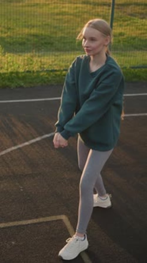 Aerial View of Young Girl Practicing Volleyball with Friend on Outdoor Court