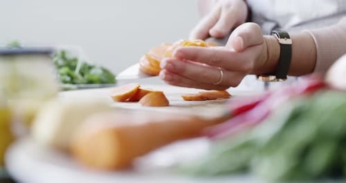 Close Up Hands Slicing Carrots