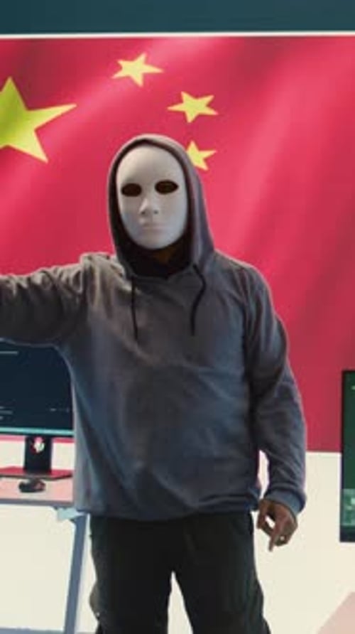 Masked Hacker Gesturing Before Computer Screens