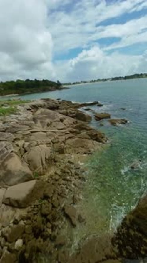 Sea and Coast, Brittany, France - A Rugged Rocky Coastline Curves Beside Clear Blue Water, with a