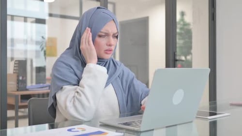 Young Adult Woman in Hijab Working on Laptop