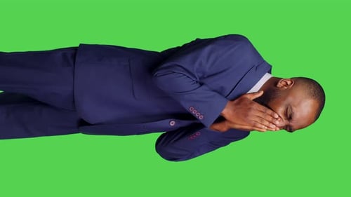 Vertical Video Side View of Young Adult Yawning and Feeling Tired in Studio