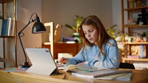 Focused Schoolgirl Talking Online Lesson Looking Tablet at Apartment Closeup