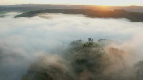 Aerial View of Fog-Covered Rural Landscape at Sunrise