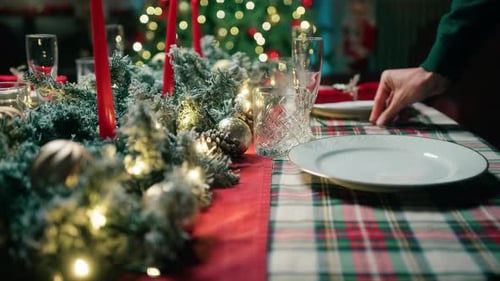 Setting Christmas Dinner Table with Holiday Decorations