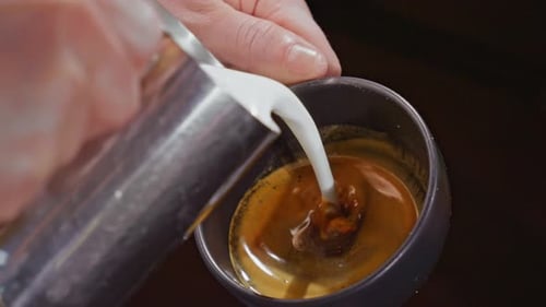 Milk Pouring Into Espresso Coffee Close Up