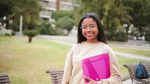 Happy Hispanic School Girl with Glasses Smiling and Laughing Out of Class