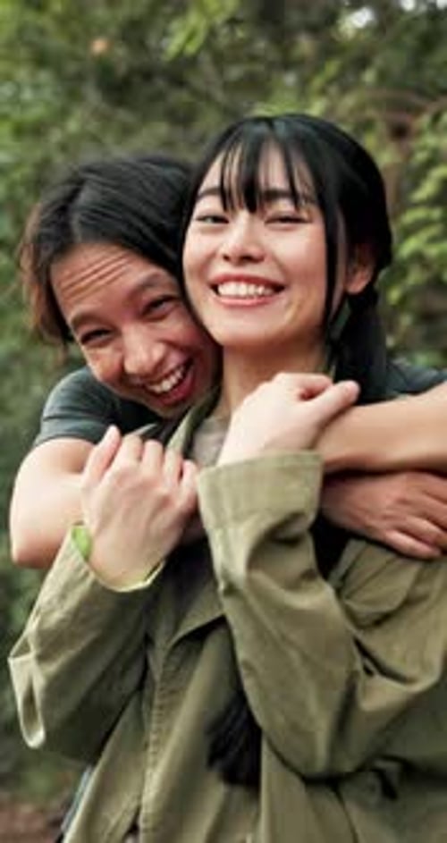 Happy Friends Embracing in a Forest