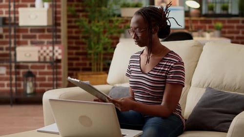 Woman Works From Home Office on Sofa