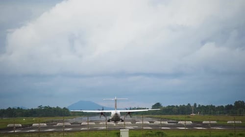 A White Passenger plane flies over the take-off strip from the airport