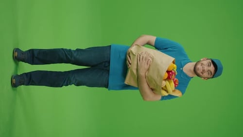 Vertical Video Green Screen Delivery Man Brings Paper Bag with Food