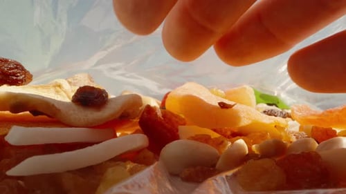 Hand Reaching into Dried Fruit Trail Mix