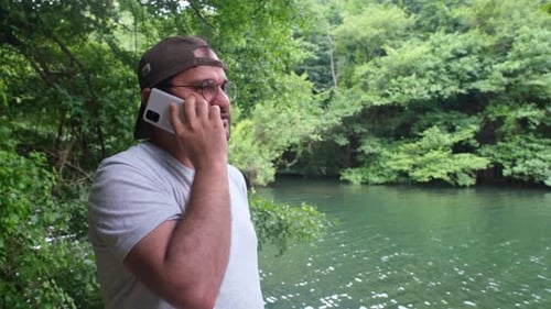Man Talking on Cell Phone By Lake
