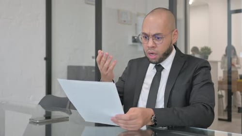 Worried Business Person Reading Bad News in Office
