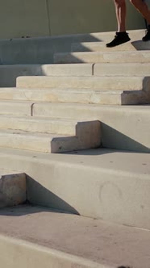 Man Running Down Concrete Urban Steps Outdoors