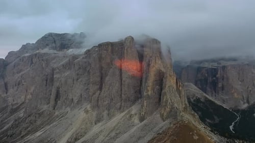 Tracking drone video showing low level clouds covering the Dolomites, Italy