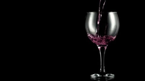 Red Wine Pouring Into a Glass in Studio