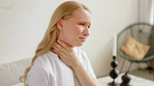Woman with Throat Pain Holding Her Neck