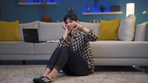 Concerned Woman Sitting on Floor at Home