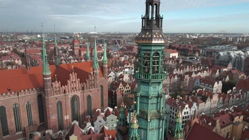 Aerial orbit over Gdansk Town Hall revealing St. Mary's Church in Gdansk