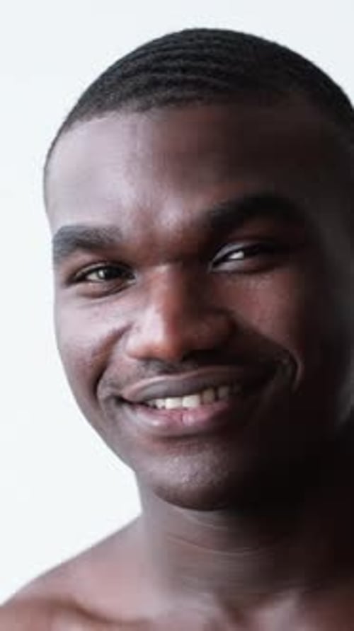 Young Man Smiles in Close Up Portrait