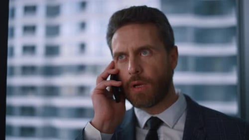 Focused Entrepreneur Making Call Using Mobile Phone in Financial Office. Portrait Of