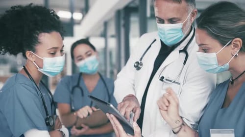 Medical Professionals Collaborating with a Tablet in Hospital