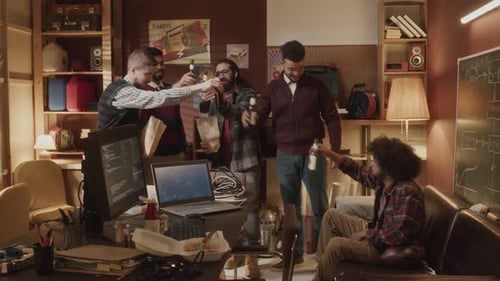Young Adults Toasting in Relaxed Office Environment