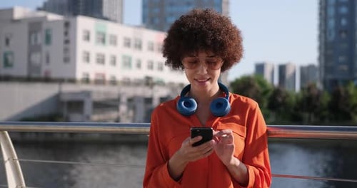 Young Woman Using Smartphone in City