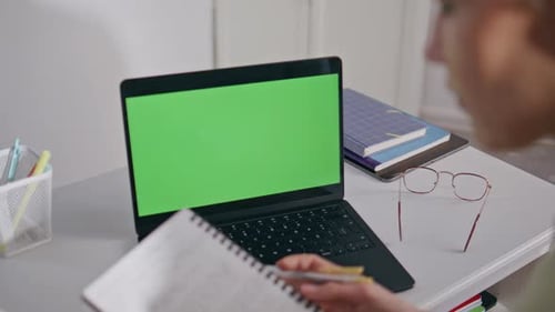 Tutor Checking Notes Mockup Laptop Workplace Closeup Woman Looking Green Screen