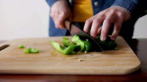 Slicing Fresh Green Bell Pepper in Kitchen