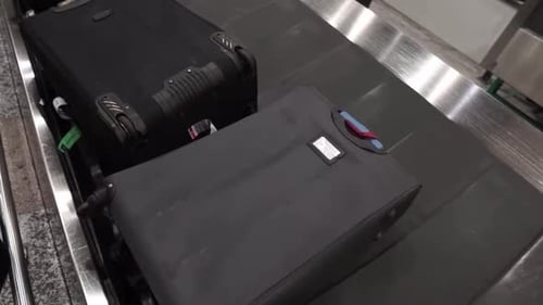 Various luggage baggage with tags moving circle on a luggage carousel for passengers arriving in Eur