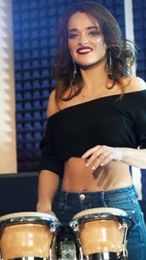 Woman playing drums in a professional recording studio. Vertical video