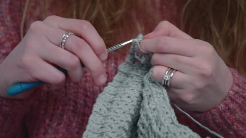 Woman Knits With Crochet At Home - Female Hands With Hook And Yarn - close up