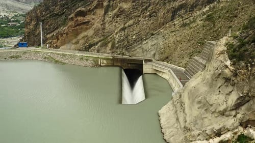 Hydroelectric Dam Outlet By Mountain