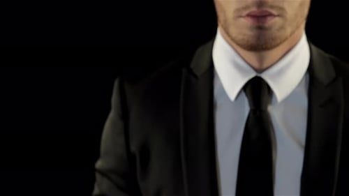 Man in Suit Raises Fist in Determination