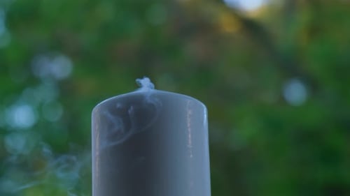 White Candle Burns Candlestick White Burning Candle with Blazing Flames Tongues of Fire on Green