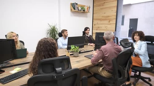 Group of Colleagues Working Together on Project in Office