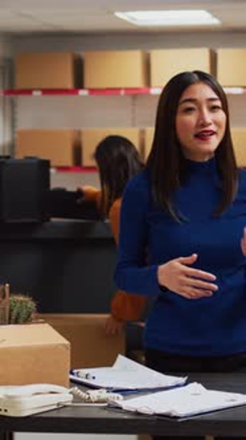 Smiling Woman Talking in Office with Cardboard Boxes