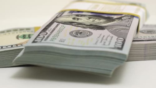 Stack of Bank Bundles with US Dollars on a White Background Closeup Shot of New Freshly Printed