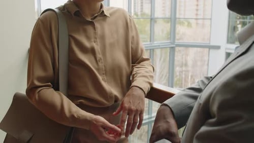 Business Colleagues Speaking in Office Foyer