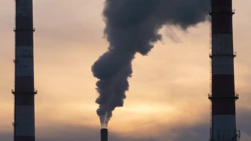 Golden hour in the city. Smokes coming out of factories. Sunset during winter.
