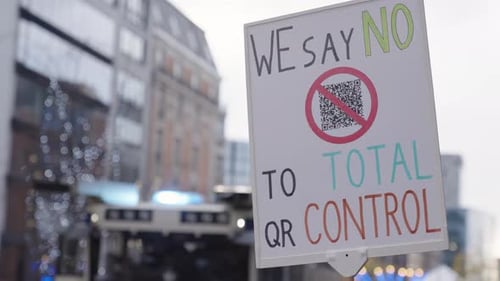 Sign Protesting Total QR Control in Urban Setting