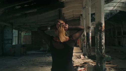 Blonde Woman Walking in Abandoned Building rear view