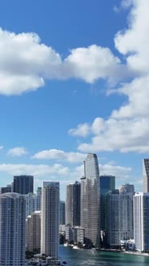 Sunlit Aerial Panorama Showcasing Miami City Center with Highrise Towers Along the Calm Bay Waters
