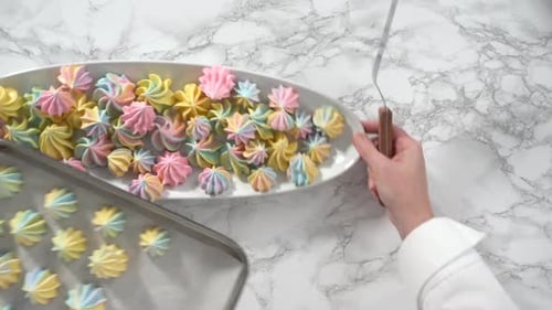 Step By Step Flat Lay Freshly Baked Unicorn Meringue Cookies on a Baking Sheet with a Parchment