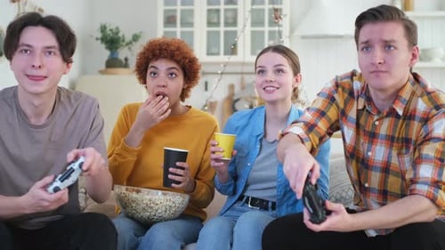 Home Party Cheerful Group of Friends Playing Video Games at Home Happy Diverse Group Buddies Having