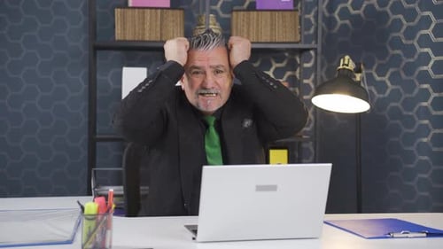 Motivated Man Excitedly Working at Office Desk