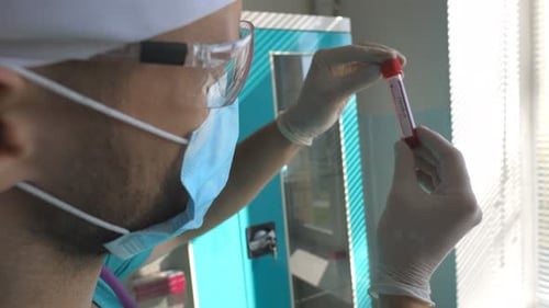 Profile of Scientist Testing Test Tube with Blood Sample to Coronavirus Young Laboratory Worker in