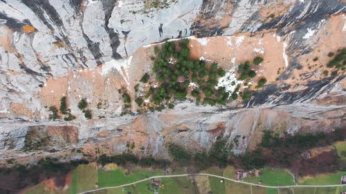 Aerial top down view of steep colorful mountainside canyon, Switzerland
